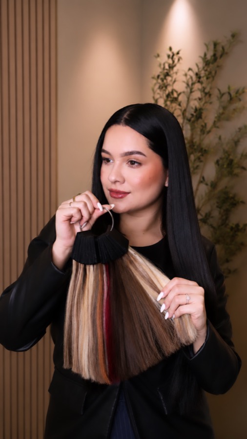 Zul presenting a ring of hair extension color swatches
