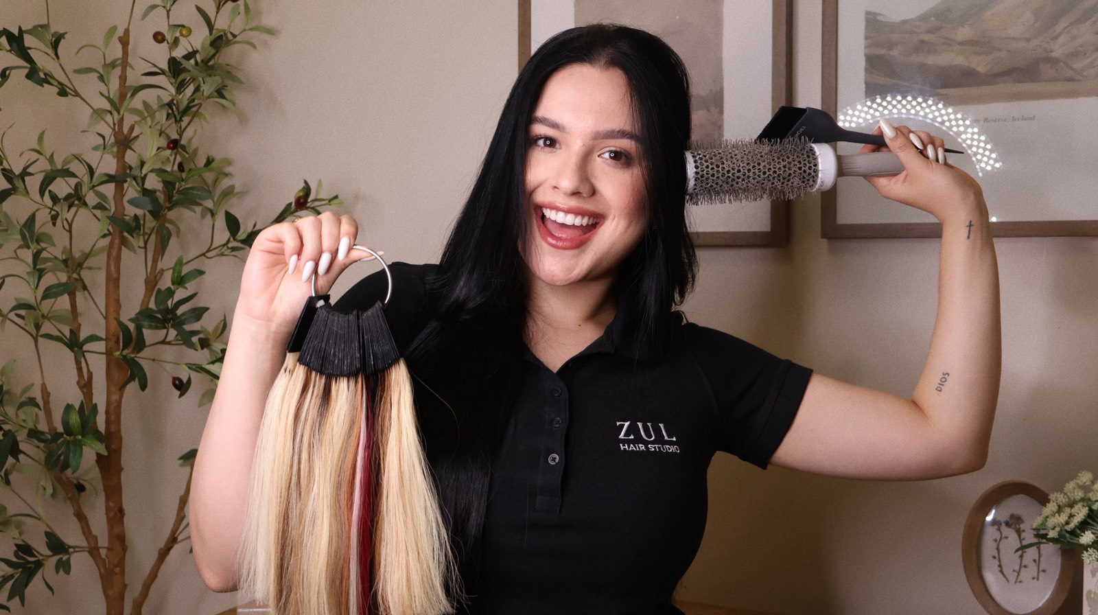 Zul styling hair while holding hair color swatches